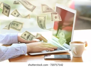 money-flying-out-laptop-while-260nw-720717142